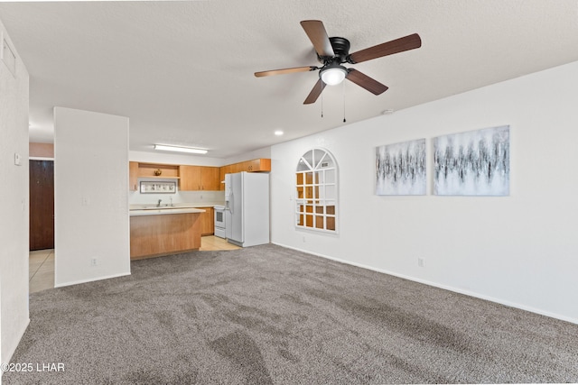 2094 Mesquite Ave Unit 113, Lake Havasu City, AZ 86403 - unfurnished living room featuring light carpet and a ceiling fan