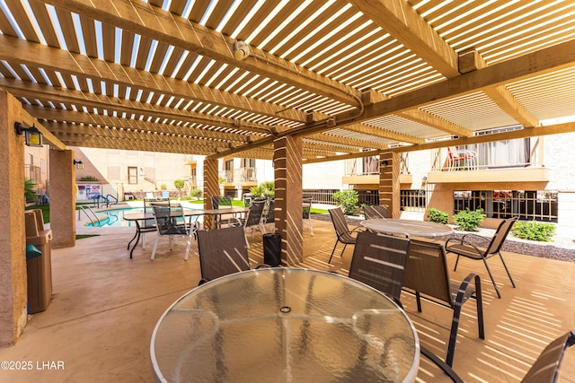 2094 Mesquite Ave Unit 113, Lake Havasu City, AZ 86403 - view of patio / terrace with outdoor dining area, a pergola, and a community pool