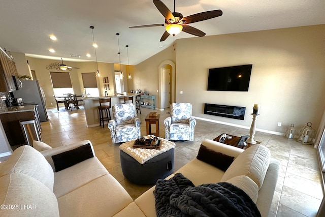 2969 Pony Cir, Lake Havasu City, AZ 86406 - living area featuring ceiling fan, recessed lighting, lofted ceiling, a glass covered fireplace, and arched walkways