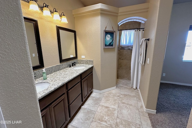 2969 Pony Cir, Lake Havasu City, AZ 86406 - bathroom featuring healthy amount of natural light, double vanity, a tile shower, and a textured wall