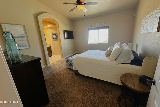 2969 Pony Cir, Lake Havasu City, AZ 86406 - bedroom featuring arched walkways, carpet flooring, ensuite bathroom, and ceiling fan