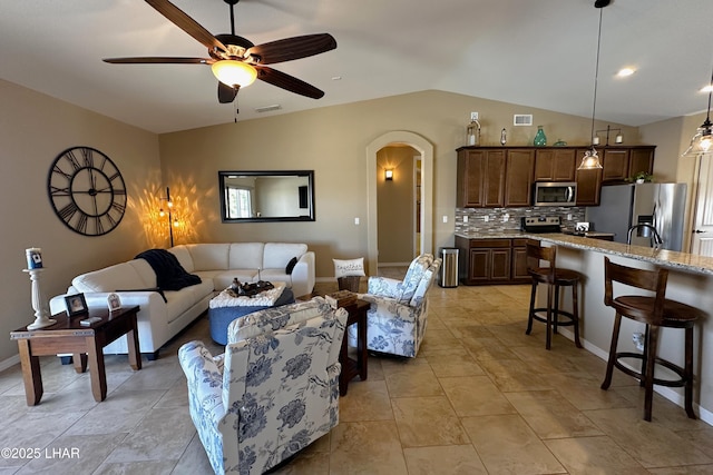 2969 Pony Cir, Lake Havasu City, AZ 86406 - living room featuring lofted ceiling, arched walkways, and a ceiling fan