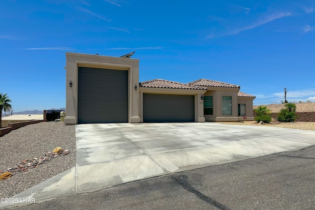 2969 Pony Cir, Lake Havasu City, AZ 86406 - view of front of property featuring an attached garage, stucco siding, driveway, and a tiled roof