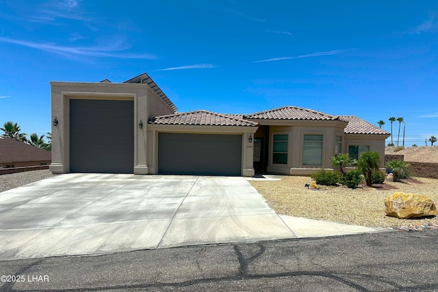 2969 Pony Cir, Lake Havasu City, AZ 86406 - view of front facade with a garage, stucco siding, concrete driveway, and a tile roof