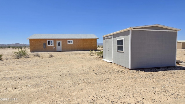 16457 S Lynn Ave, Yucca, AZ 86438 - rear view of property featuring an outdoor structure
