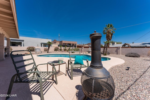 view of swimming pool featuring a fenced backyard, a patio, and a fenced in pool
