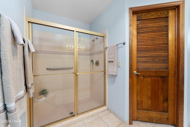 full bath with tile patterned flooring and a stall shower