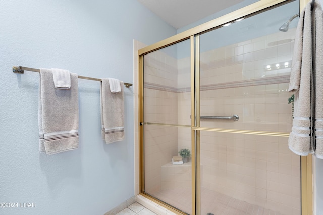 bathroom with tile patterned flooring and a stall shower