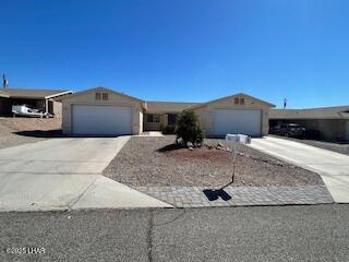 ranch-style home with concrete driveway and an attached garage