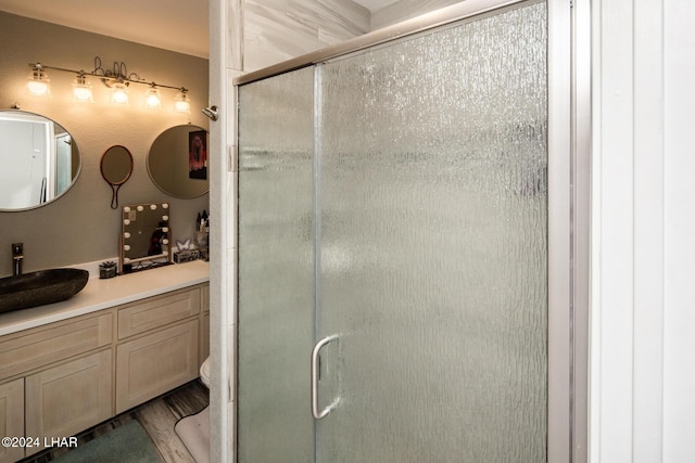 bathroom featuring vanity, hardwood / wood-style flooring, and walk in shower