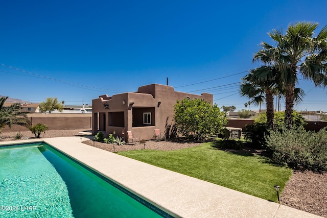 view of pool with a yard