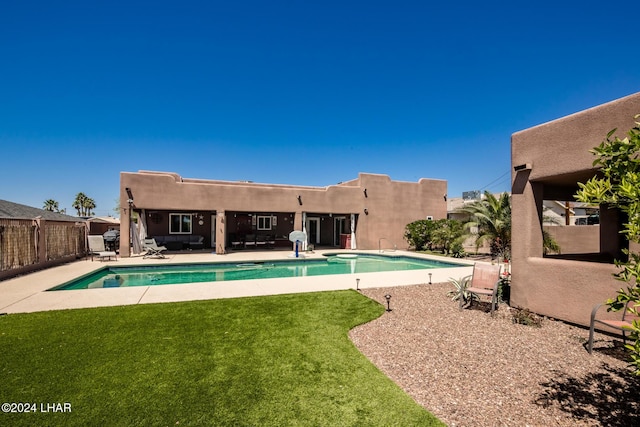 view of swimming pool with a patio and a lawn