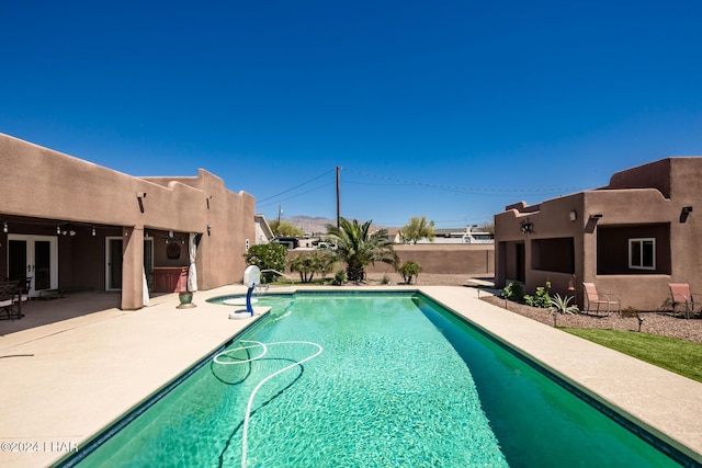 view of pool featuring a patio and french doors