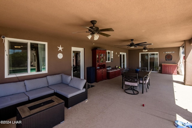 view of patio with an outdoor living space and ceiling fan