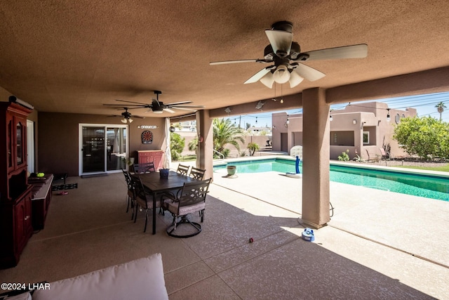 view of pool with a patio and ceiling fan