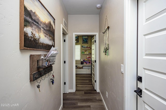 hall with baseboards and dark wood-style flooring