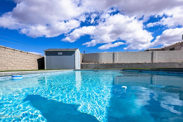 view of swimming pool with a storage shed, an outbuilding, fence, and a fenced in pool