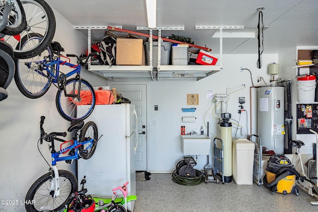 garage with water heater and freestanding refrigerator