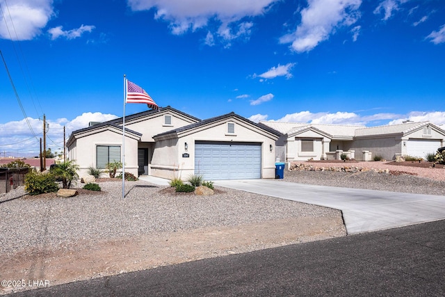 view of front facade with driveway, a garage, and stucco siding