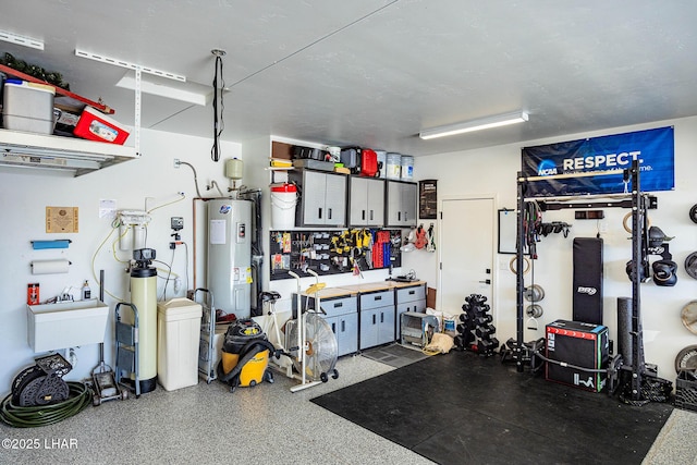 garage featuring electric water heater and a workshop area