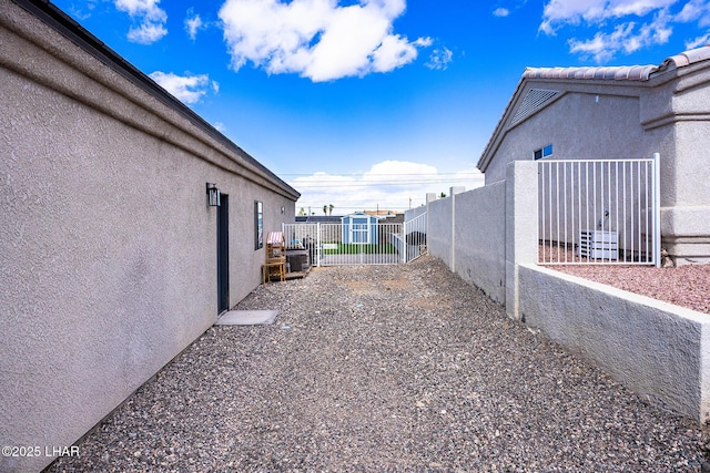 view of yard with a storage unit, fence, and an outbuilding