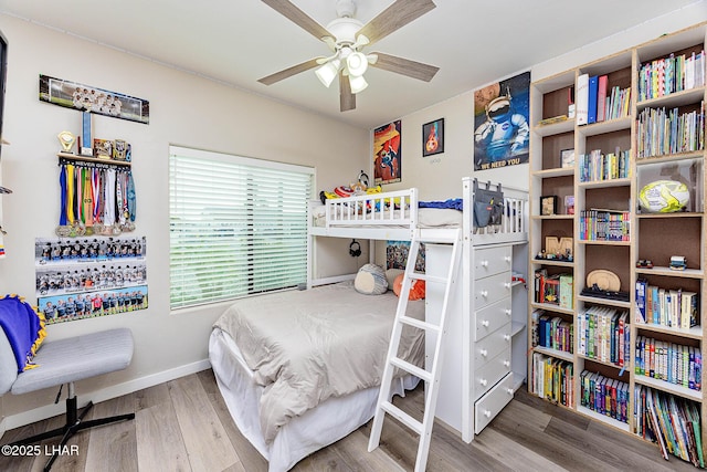 bedroom featuring baseboards and wood finished floors