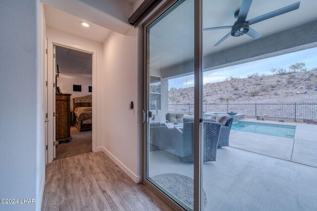 interior space featuring wood-type flooring and ceiling fan