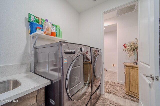 laundry area featuring hardwood / wood-style floors and washer and dryer