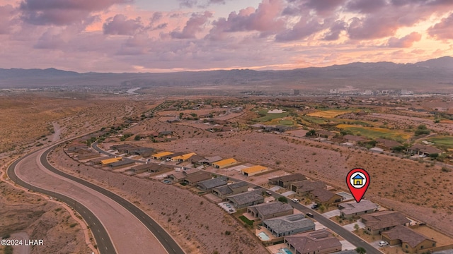 aerial view at dusk featuring a mountain view