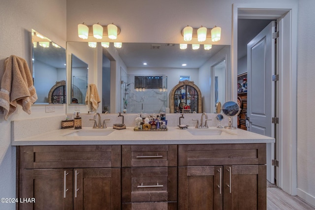 bathroom with vanity, wood-type flooring, and walk in shower