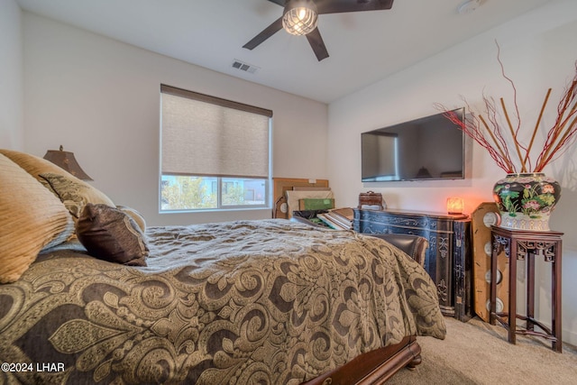 bedroom featuring light colored carpet and ceiling fan