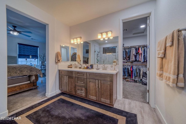 bathroom with ceiling fan, vanity, and hardwood / wood-style floors