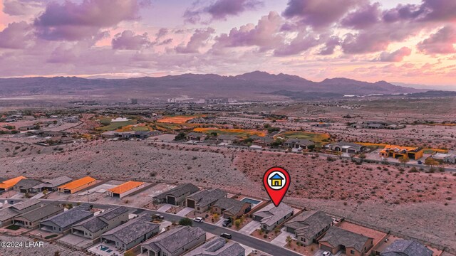 aerial view at dusk featuring a mountain view