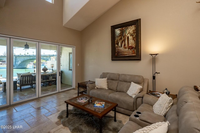 1415 Mcculloch Blvd N Unit 102, Lake Havasu City, AZ 86403 - living room featuring stone tile flooring, a ceiling fan, and high vaulted ceiling