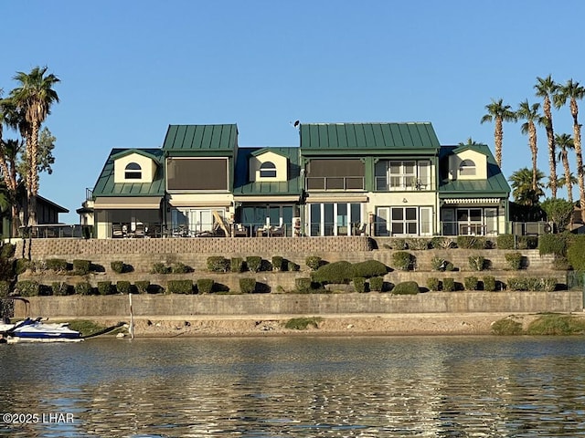 1415 Mcculloch Blvd N Unit 102, Lake Havasu City, AZ 86403 - back of property featuring a standing seam roof, fence, a water view, and metal roof