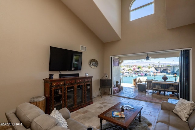 1415 Mcculloch Blvd N Unit 102, Lake Havasu City, AZ 86403 - living room with a high ceiling, a ceiling fan, stone tile flooring, and visible vents