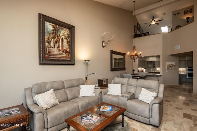 1415 Mcculloch Blvd N Unit 102, Lake Havasu City, AZ 86403 - living room featuring ceiling fan with notable chandelier, stone finish floor, vaulted ceiling, and visible vents