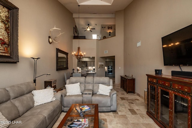 1415 Mcculloch Blvd N Unit 102, Lake Havasu City, AZ 86403 - living area featuring baseboards, ceiling fan with notable chandelier, stone finish floor, and high vaulted ceiling