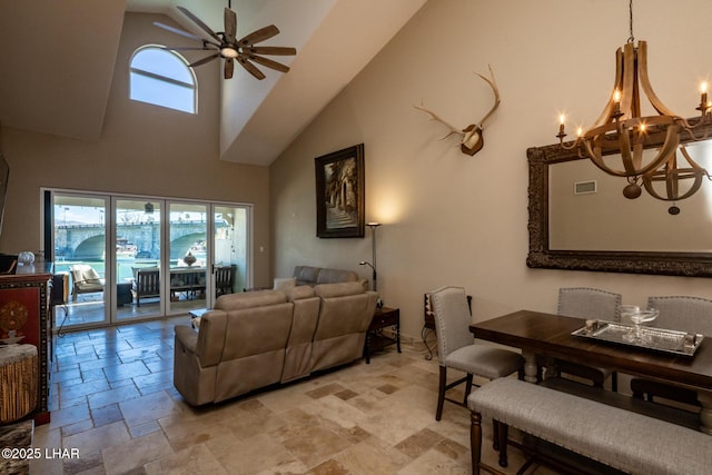 1415 Mcculloch Blvd N Unit 102, Lake Havasu City, AZ 86403 - living room with stone tile floors, high vaulted ceiling, visible vents, and ceiling fan with notable chandelier