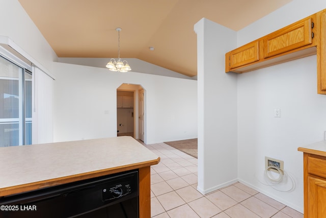 kitchen with pendant lighting, light tile patterned floors, lofted ceiling, and dishwasher