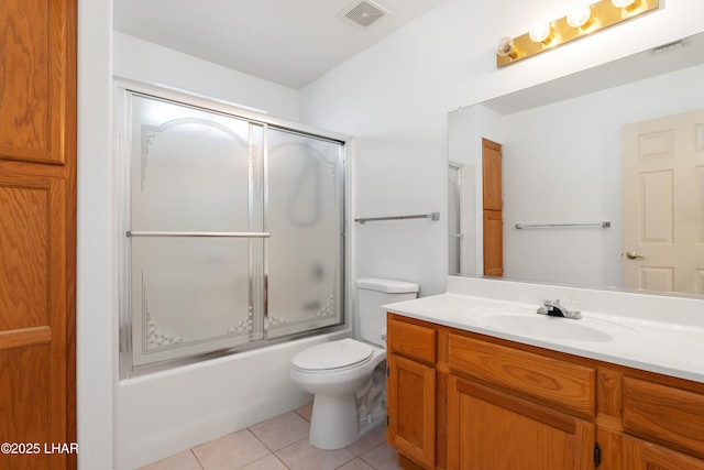 full bathroom featuring toilet, tile patterned floors, bath / shower combo with glass door, and vanity