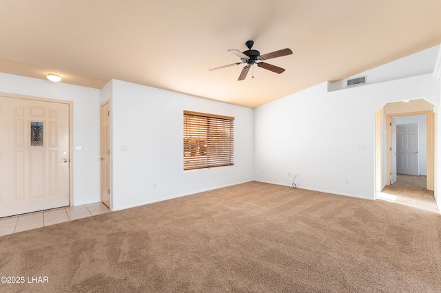 unfurnished room featuring ceiling fan, vaulted ceiling, and light carpet