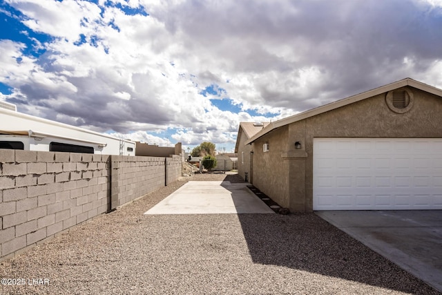 view of side of home with a garage and an outdoor structure