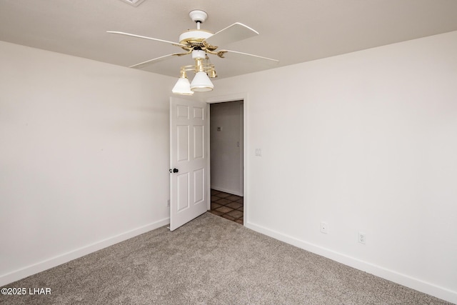 unfurnished room featuring carpet flooring, a ceiling fan, and baseboards