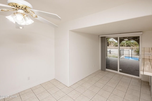 spare room featuring light tile patterned floors and ceiling fan