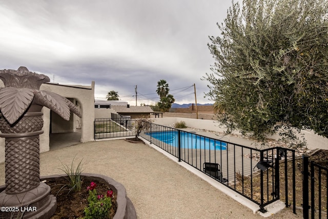 view of swimming pool featuring a patio area, a fenced in pool, and fence