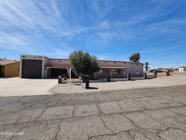 view of front of property featuring a garage, driveway, and stucco siding