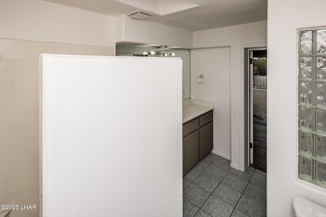 bathroom featuring tile patterned floors, visible vents, toilet, and vanity