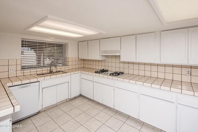 kitchen featuring white appliances, light tile patterned flooring, tile counters, white cabinetry, and tasteful backsplash