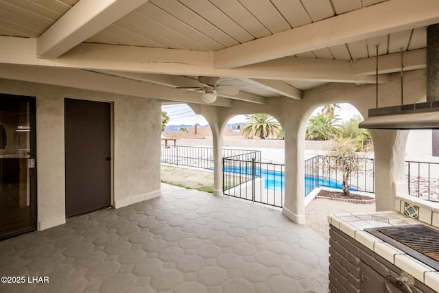 view of patio featuring a fenced in pool, a fenced backyard, and a ceiling fan